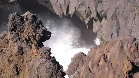 HD slow-motion shot, waves hitting sea cave with rainbow. Lanzarote Stock Footage 168346301