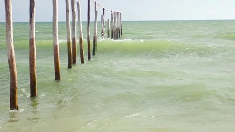 HD, Slow motion. Waves crashing against wooden sticks Stock Footage 82619504