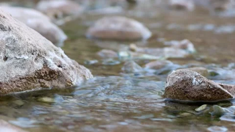 HD a stream of water that flows between the natural stones. Stock Footage