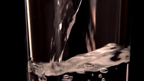 HD Super Slow-Mo Pouring Wine In The Glass Pouring water into a full glass an Stock Footage 265845364