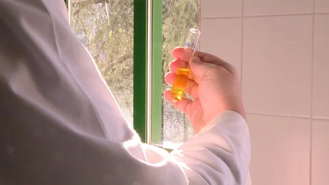 HD Test tube with a yellow solution Stock Footage 82618478