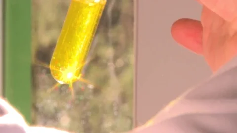 HD Test tube with a yellow solution Stock Footage 82618484