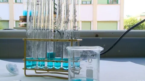 HD Test tubes and beaker with a blue solution Stock Footage 82618533