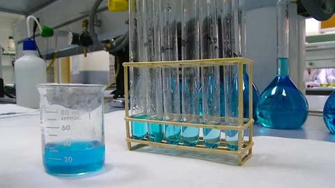 HD Test tubes and beaker with a blue solution. Stock Footage 82618538
