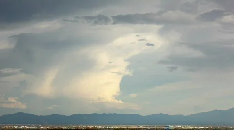 HD - Thunderhead converts to gigantic lenticular and spreads over mountains Stock Footage