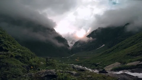 HD time-lapse | Sun shining through moving clouds of Himalayan Mountain Valley. Stock Footage