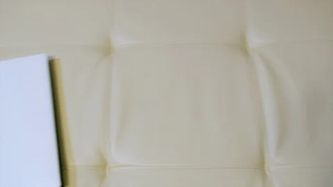 HD Top view of a paper notebook laying on a sofa Vidéo 96214810