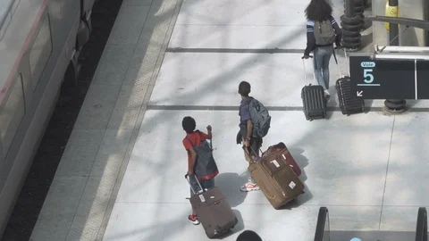 HD Travellers at train station terminal board train with suitcases Stock Footage 120134273