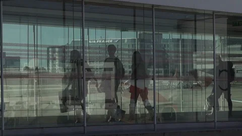 HD Travellers walk through shiny glass jet bridge toward airport terminal  Stock Footage 120135174
