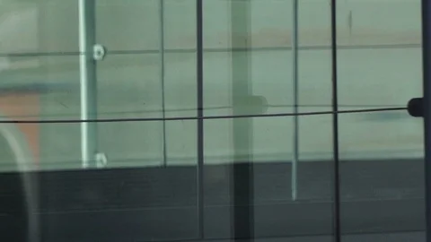 HD Travellers walk through shiny glass jet bridge toward airport terminal V3 Stock Footage 120135271