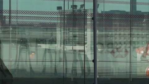 HD Travellers walk through shiny glass jet bridge toward airport terminal V5 Stock Footage 120135391