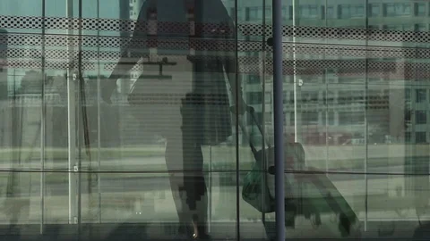 HD Travellers walk through shiny glass jet bridge toward airport terminal V6 Stock Footage 120135441