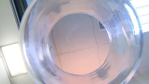 HD Two researchers add a solution to a flask Stock Footage 82618396