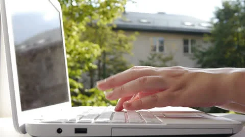 HD - Typing on a Notebook keyboard. City view Stock Footage 24956282