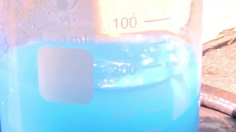 HD Unfocused image of a bluish solution Stock Footage 82618540