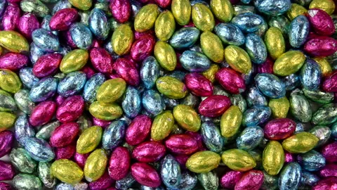 HD Video background of easter candy, hand places craft easter bunnies Stock Footage 150143728