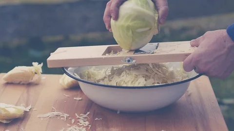 Hd video shows how to use a wooden cabbage shredder - slow motion Stock Footage 87269133