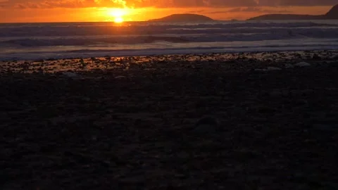 HD waves breaking across the horizon of Bardsey Island during sunset,  Wales 動画素材 196748610
