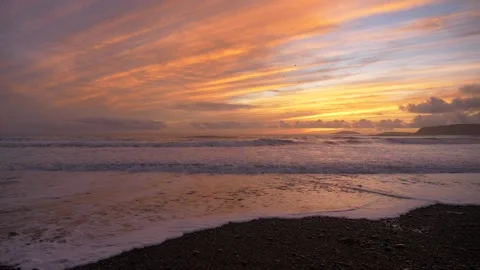HD of waves breaking along the shore during sunset Stock Footage 196748598