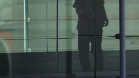 HD Young boy runs through airport jet bridge, stops to look out Stock Footage 120135134