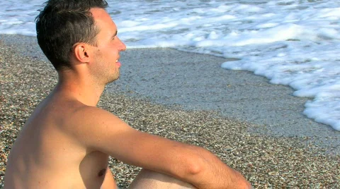 HD young guy sitting on the beach  Stock Footage 479612