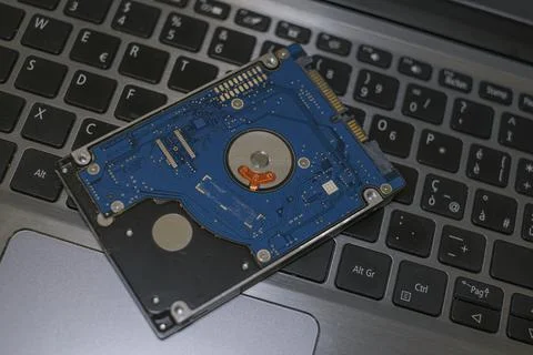 Hdd memory storage device over dark surface,tech components,data security parts Stock Photos