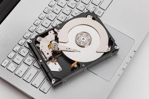 HDD over notebook keyboard Stock Photos