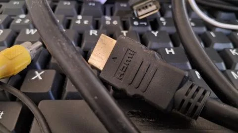 HDMI cable on a computer keyboard. Digital connection hardware for high Foto stock