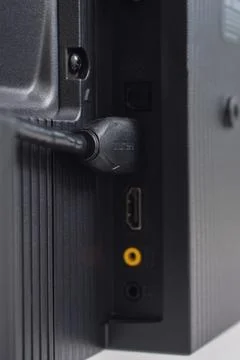 The HDMI cable is connected to the TV Stock Photos