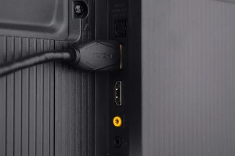 The HDMI cable is connected to the TV Stock Photos