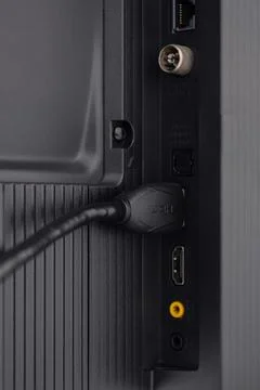 The HDMI cable is connected to the TV Stock Photos