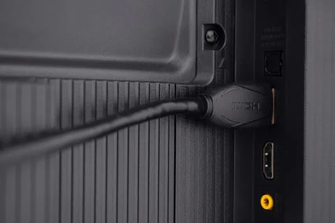 The HDMI cable is connected to the TV Stock Photos