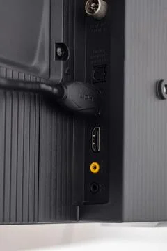 The HDMI cable is connected to the TV Stock Photos