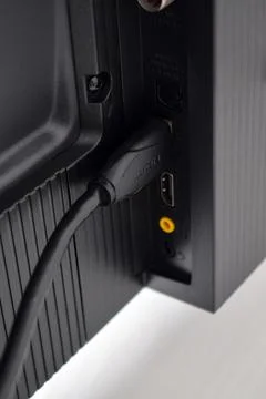 The HDMI cable is connected to the TV Foto stock