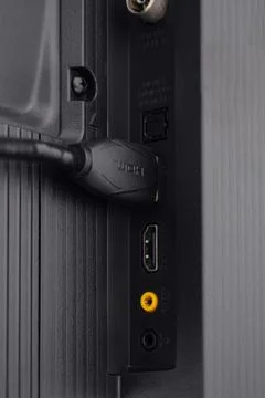 The HDMI cable is connected to the TV Stock Photos