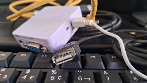 HDMI cable connected to white gaming console. High-speed video connector plugged Stock Photos