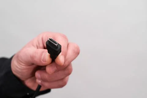 HDMI plug in hand on white background. Stock-Fotos