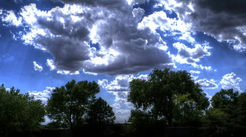 HDR Clouds Over Silhouette of Trees Stock Footage 836158