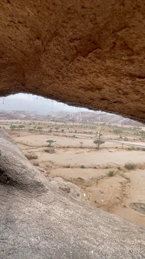 HDR Rainfall View from Inside a Cave in the Desert Mountains Stock Footage 319674477