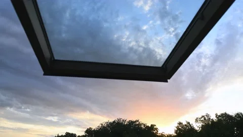 HDR time Lapse of sunset sky full of clouds from attic window 스톡 동영상 133988046