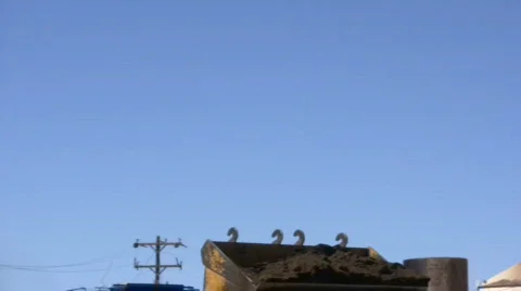 HDV: Bucket Dumping Tracking Shot Stock Footage 108636