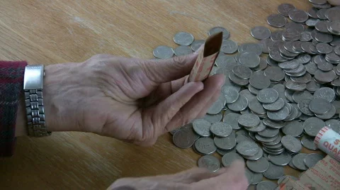 HDV: Man Rolling Quarters Stock Footage 101070