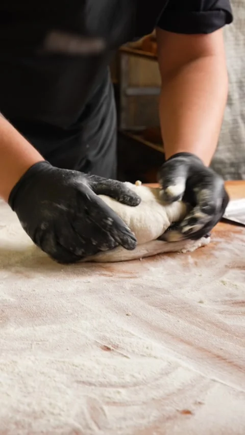 He baker prepares the dough for bread fresh fluffy bread dough Stock Footage 261250399