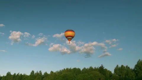 He balloon is flying low over the ground, the balloon is flying over the forest Stock Footage 208342655