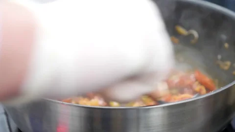He chef prepares a black paste with seafood and whiskey at the festival of food Stock Footage 84263805