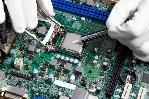 He close up image of technician squeezing the fresh thermal paste compound .. Stock Photos
