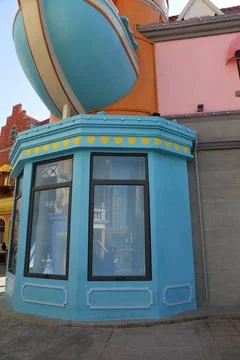 He corner of the building is painted in light blue, with an orange and pink.. Stock Photos