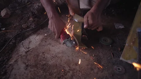 He is cutting a large iron rod with a grinding machine closeup view Stock Footage 340121771