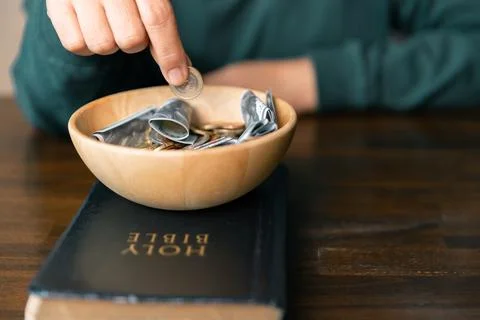 He decided to donate portion of his earnings as tithe, giving money and coi.. Stock Photos