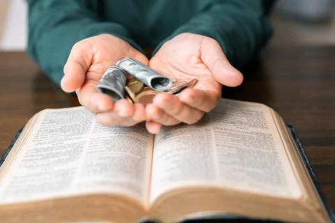 He decided to donate portion of his earnings as tithe, giving money and coi.. Stock Photos